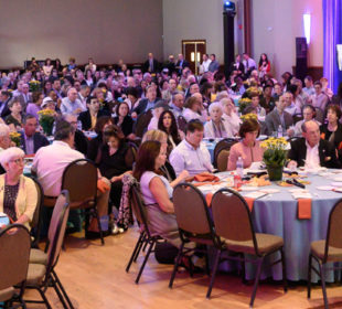 Event attendees at tables during Annual Meeting event