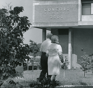 Couple walking in front of the Concord House