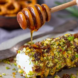 Cheese log with pistachios and a date drizzle